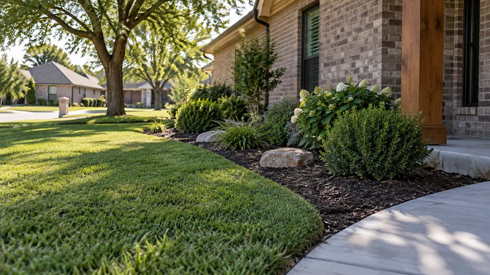 A neatly edged lawn beside a mulched planting bed.